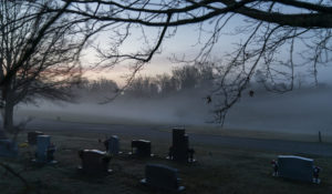 FILE - In this Wednesday, March 17, 2021 file photo, morning fog blankets a cemetery in West Virginia. The number of U.S. suicides fell nearly 6% in 2020 amid the coronavirus pandemic — the largest annual decline in at least four decades, according to preliminary government data. (AP Photo/David Goldman)